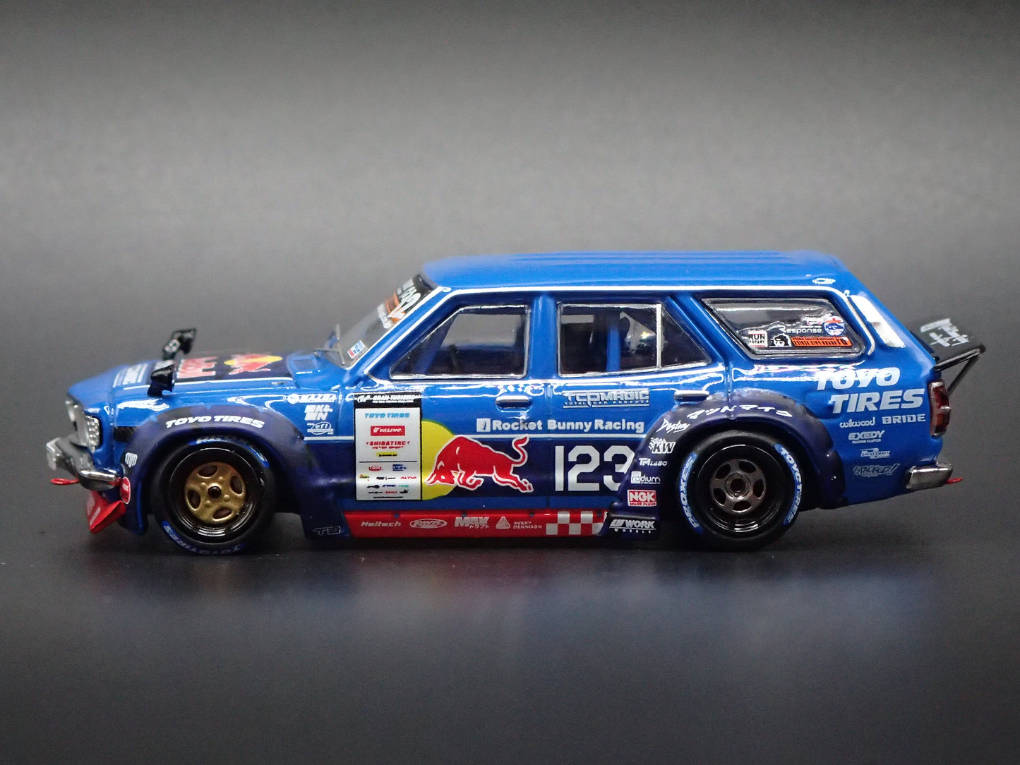 1971-1978 MAZDA RX3 STATION AGON RED BULL MAD MIKE 1:64 SCALE DIORAMA DIECAST MODEL CAR