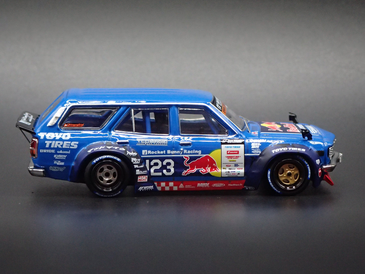 1971-1978 MAZDA RX3 STATION AGON RED BULL MAD MIKE 1:64 SCALE DIORAMA DIECAST MODEL CAR