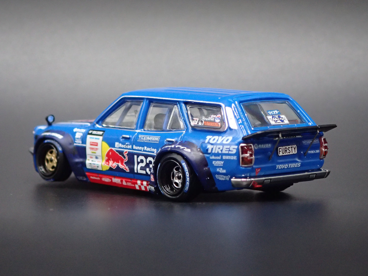 1971-1978 MAZDA RX3 STATION AGON RED BULL MAD MIKE 1:64 SCALE DIORAMA DIECAST MODEL CAR