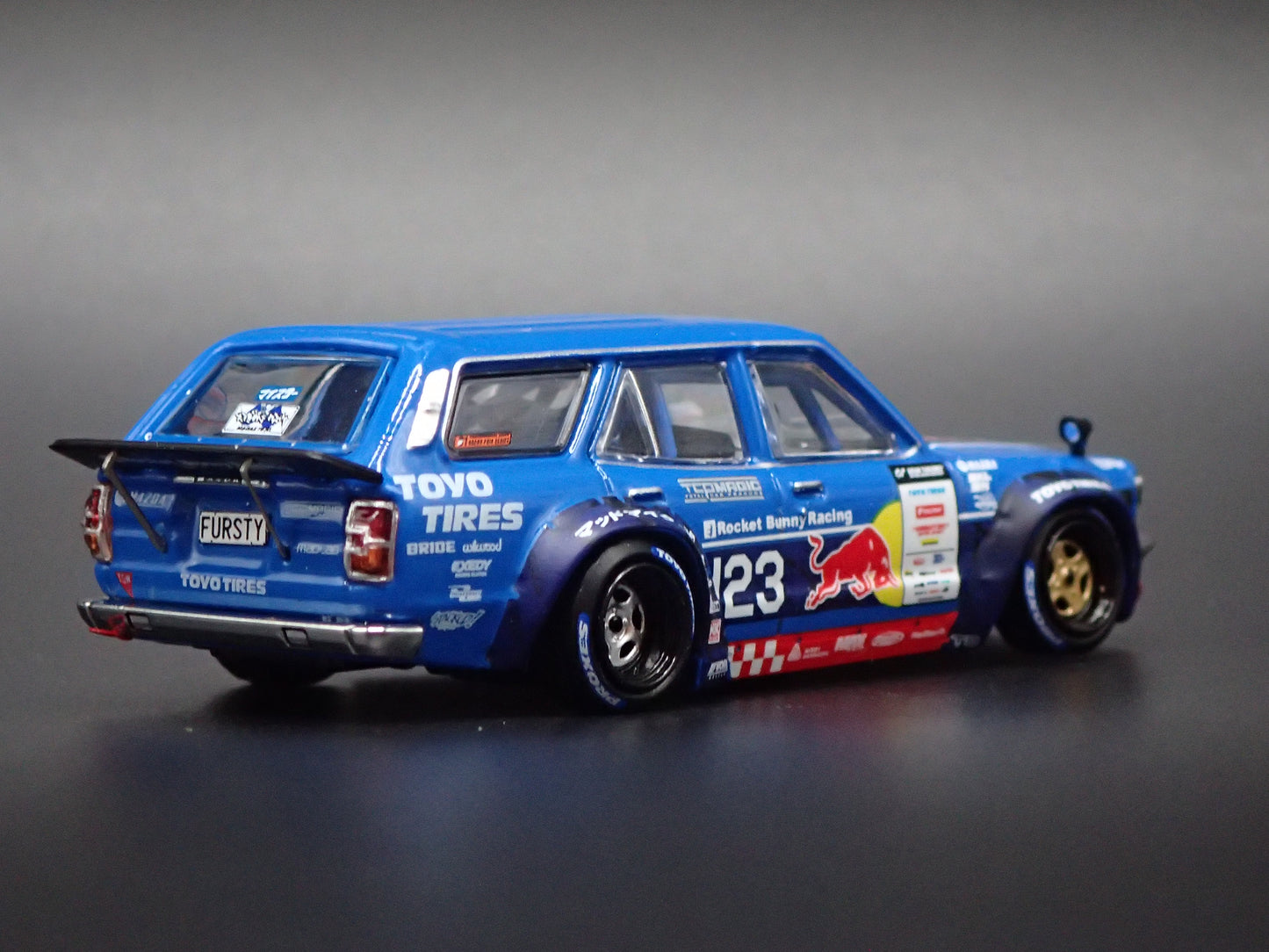 1971-1978 MAZDA RX3 STATION AGON RED BULL MAD MIKE 1:64 SCALE DIORAMA DIECAST MODEL CAR