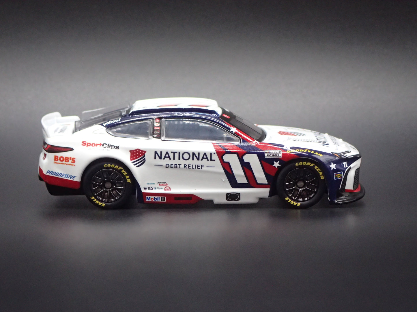 2026 26 TOYOTA CAMRY 11 DENNY HAMLIN DEBT RELIEF NASCAR 1:64 SCALE DIECAST CAR