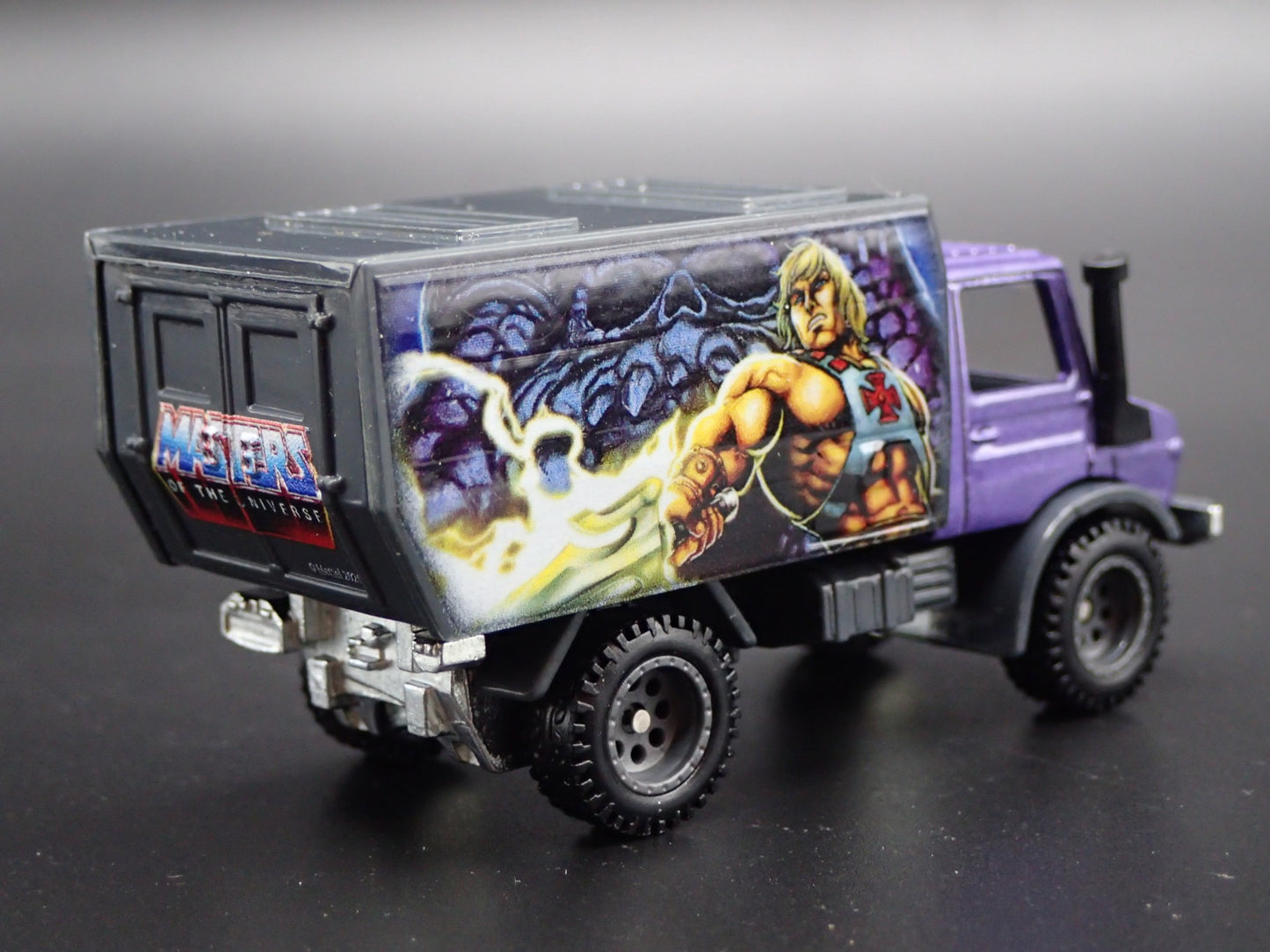 MERCEDES-BENZ UNIMOG U 1300L MASTERS OF UNIVERSE  1:64 SCALE DIECAST MODEL CAR