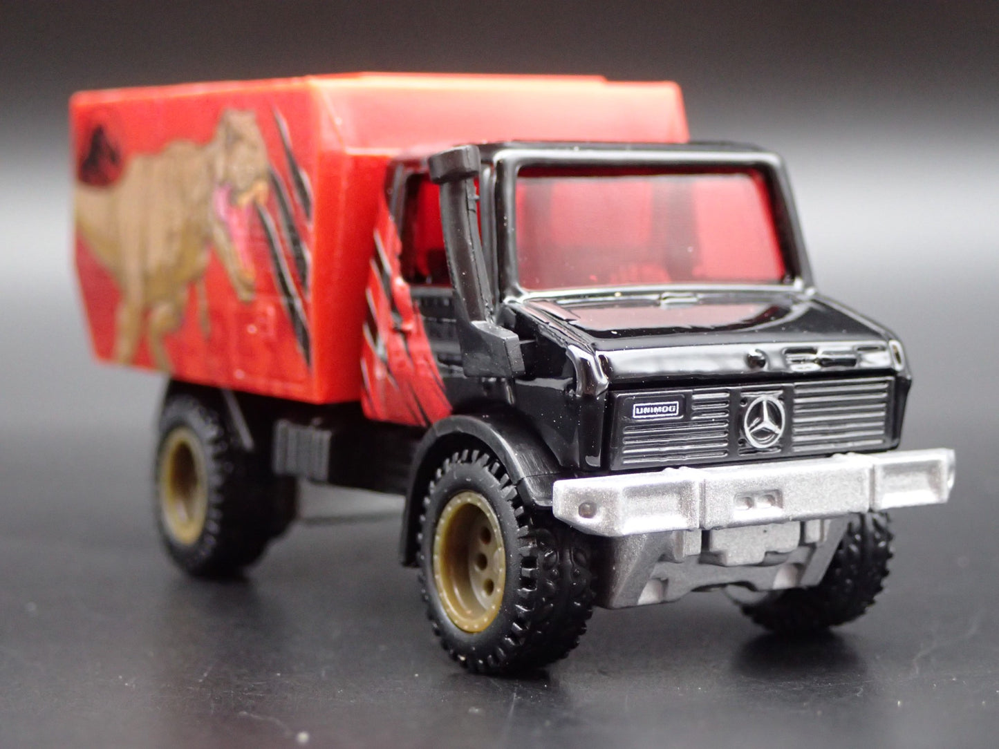 MERCEDES-BENZ UNIMOG U 1300L JURASSIC WORLD 1:64 SCALE DIORAMA DIECAST MODEL CAR