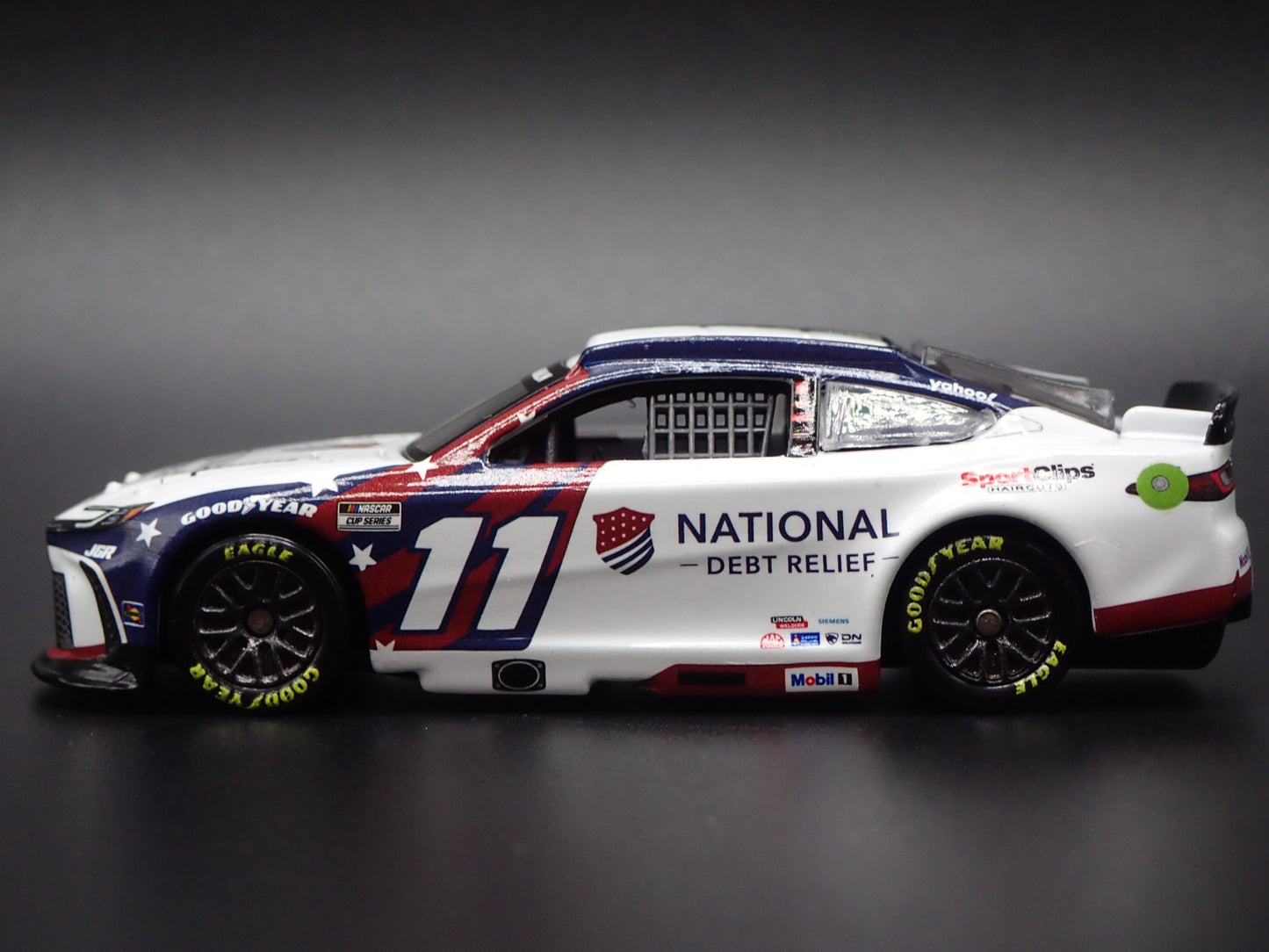 2025 25 TOYOTA CAMRY 11 DENNY HAMLIN DEBT RELIEF NASCAR 1:64 SCALE DIECAST CAR