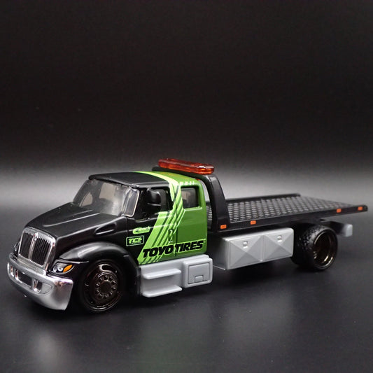 INTERNATIONAL DURASTAR FLATBED TOW TRUCK TOYO TIRES 1/64 SCALE DIECAST MODEL CAR-Burning Rubber Toy Company